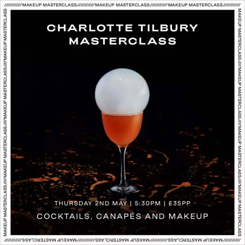 An orange coloured cocktail is topped with a large smoke filled bubble in a long stemmed glass. White words sit above the glass, which read: Charlotte Tilbury Masterclass.