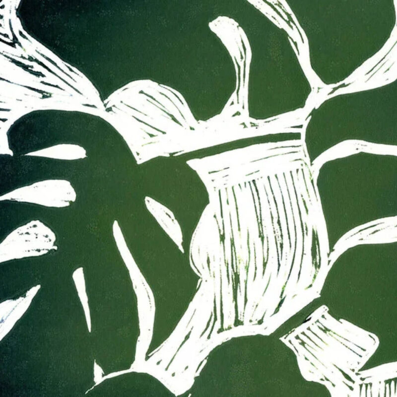 Lino print of a monstera plant. It is printed in green paint on a white background.