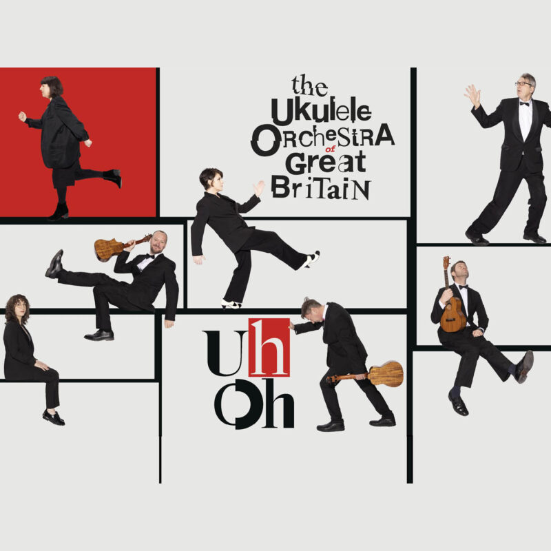 Members of the Ukulele Orchestra of Great Britain are positioned in strange poses across a black grid. Some of them walk with exaggerated steps, while others just sit on the black grid lines and look at the camera. Black text reads: The Ukulele Orchestra of Great Britain. Below it, more text reads: Uh Oh.