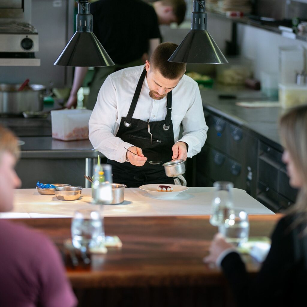 A couple watched their food get prepared with care at the Chef's Table at the SiX rooftop