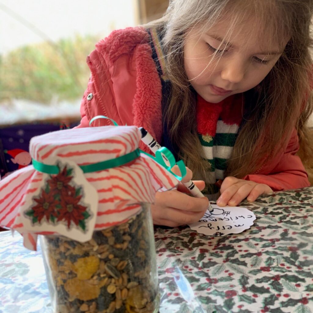 A little girl writes Merry Christmas