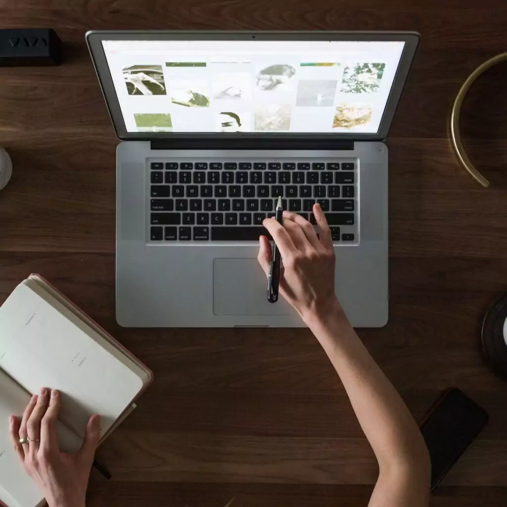 A person uses their laptop to study