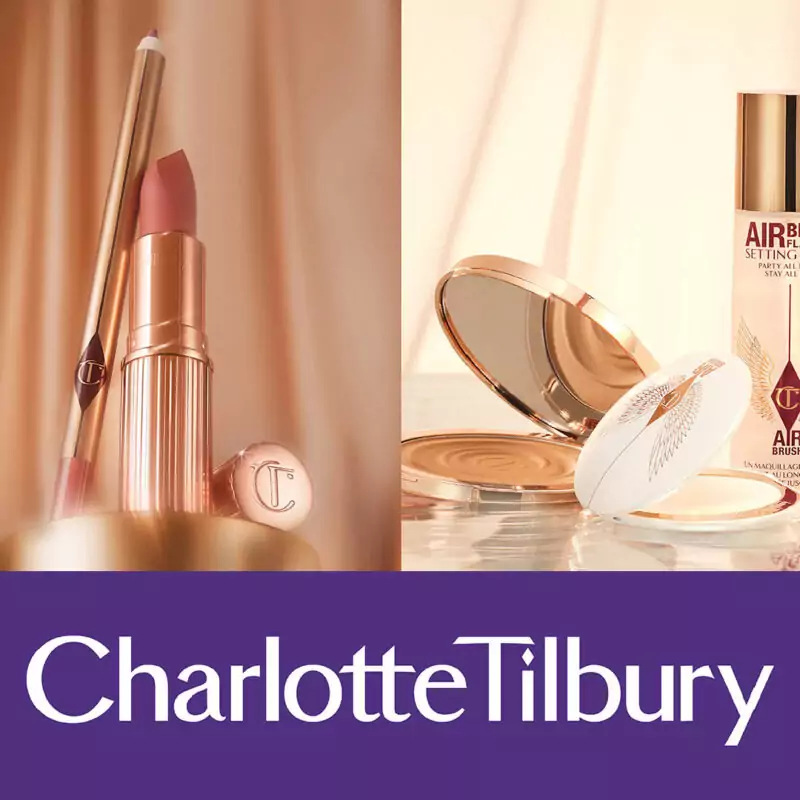 A rose gold lipstick stands upright against a dusty pink backdrop. Next to it, more makeup products like compact powder and setting spray are arranged against a cream backdrop. Below these images, a purple strip displays the white words: Charlotte Tilbury.