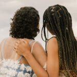 Two friends side hugging looking into the distance